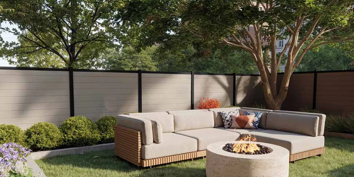 Riverside fence: matte-black aluminum frames around light horizontal vinyl infill boards, enclosing a lawn with a fire pit and seating